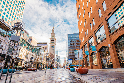 Wide Angle Shot of 16th Street Mall Downtown Denver on a Sunny Winter Day Featuring the Daniels & Fisher Clock Tower and Iconic Light Posts.

16th Street is a Popular Tourist Shopping Destination Outdoor Mall Closed to Traffic with Public Transport, Local Shops, Art, and Music.