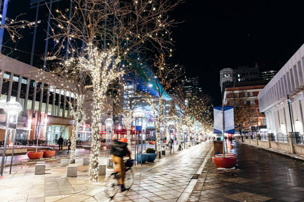 Wide Angle Shot of a Cyclist Riding on 16th Street Mall Downtown Denver on a Winter Night stock photo