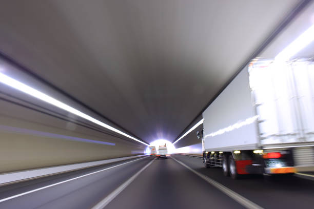 istock Truck driving through the highway tunnel 1364871622