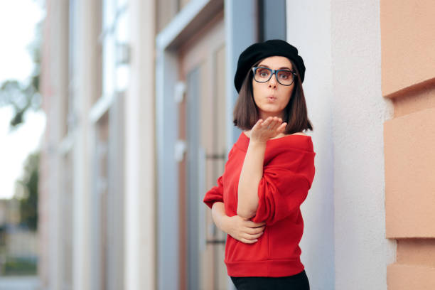 istock Chic Girlfriend Wearing a Beret Blowing a Kiss 1364876776