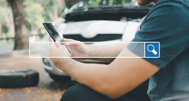 istock Searching browsing internet bar over background is Asian man using a smartphone for assistance after a car breakdown on street. Searching Browsing Internet Data Information Networking Concept 1364879247