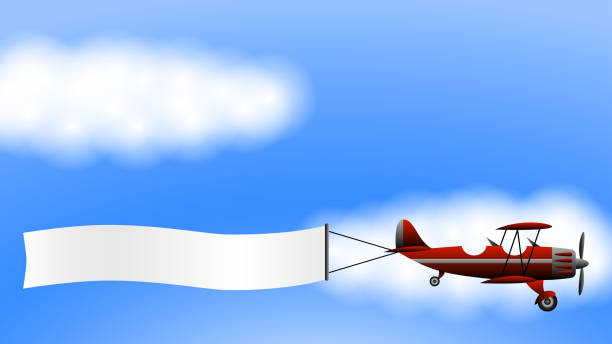 구름 의 배경에 광고 배너가있는 빨간색 복엽 비행기 - airplane banner biplane retro revival stock illustrations
