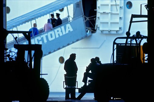 The City of Victoria on Vancouver Island  on June  12, 1995:  Passengers boarding a cruise ship ramp at the Ogden Point terminal located in the capital city of Victoria, on Vancouver Island, with terminal workers in the foreground