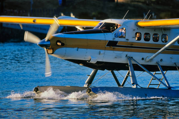 The City of Victoria on Vancouver Island  on June 14, 2002:  Seaplane taxiing the Victoria inner harbor and marina at sunset on Vancouver Island, British Columbia