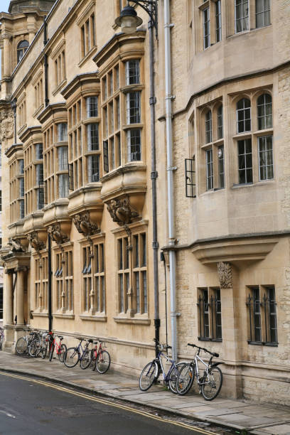 istock bicycles on sidewalk leaning against old stone college building 1364882859