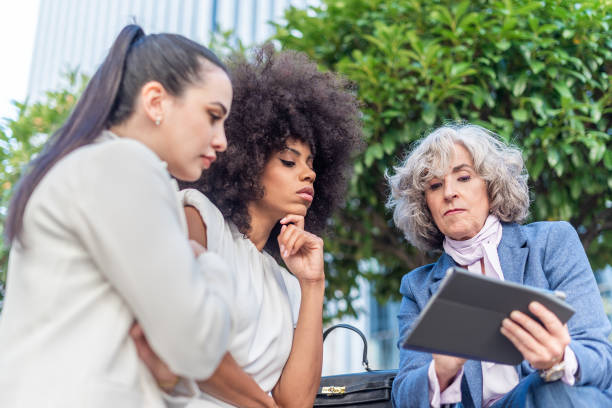 istock three female workers studying company information in the city 1364886220
