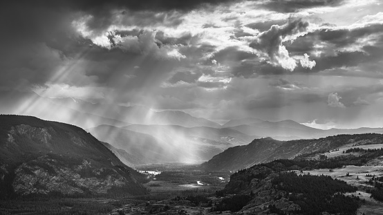 Mountain gorge in evening light, sunbeam, black and white landscape