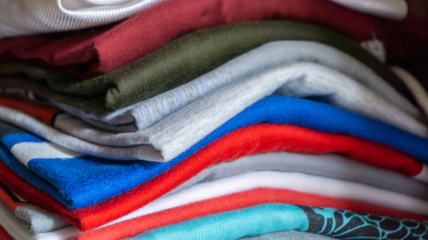 istock Stack Of clothes inside the wardrobe closet. stack of clothes in storage 1364887032