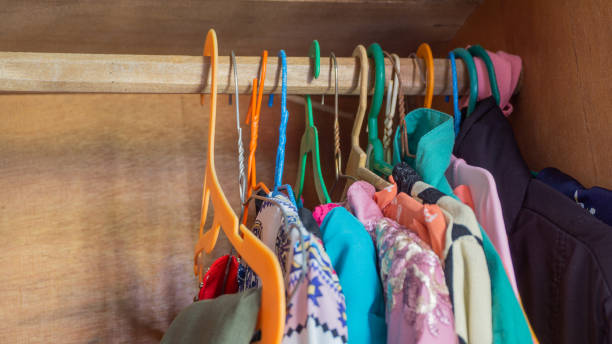 istock Hangers with different clothes in the wardrobe 1364887604