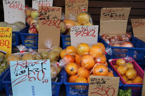 2023-11-11 Osaka, Japan. Customers shopping for fresh fruits and vegetables at a market in Osaka, Japan