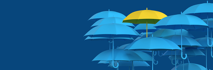 Saving up for rainy day and Leadership-Teamwork Concept: Many 3d rendered blue colored umbrellas and diverse yellow umbrella standing out from the crowd. Dark blue background with copy space. Creative idea illustration for office poster presentation. Think differently. Series of 5 files.