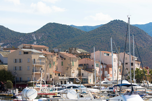 Beautiful view of the fishing village Saint Florent. Mediterranean sea and the corsican mountain range the Background. Tourism and vacations concept.