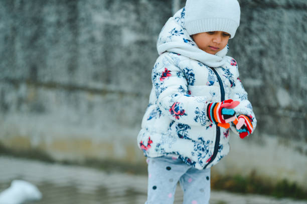 istock african kid in winter playing with snow 1364897800