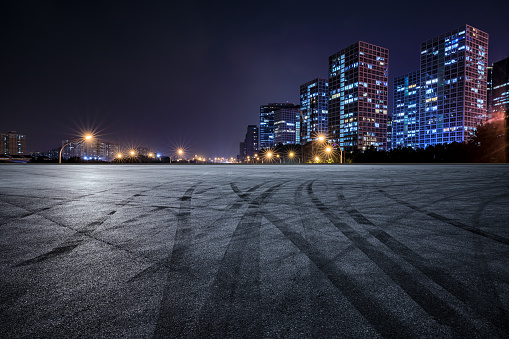 Panoramic skyline and modern commercial buildings with empty asphalt road in Beijing, China.