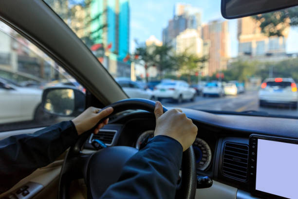istock People driving car on city road 1364900450