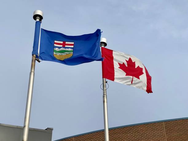 istock An Alberta Flag with the Canadian flag  during a windy day 1364901522