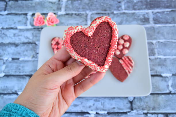 istock Heart-shaped red Valentine's cookies decorated with white chocolate and sprinkles 1364902184