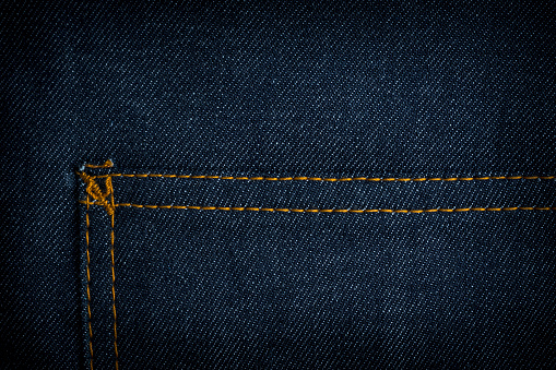 Dark blue jeans texture background with pocket.