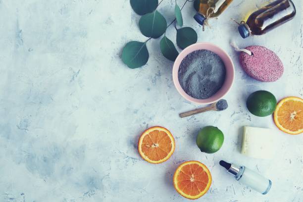 istock Blue clay, citruses, cream, herbal tinctures and aromatic oils in bottles, eucalyptus leaves on a light background 1364902409