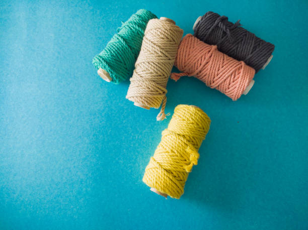 istock colorful reels of macrame cord threads or wool shot as copy space background or text background. 1364902474