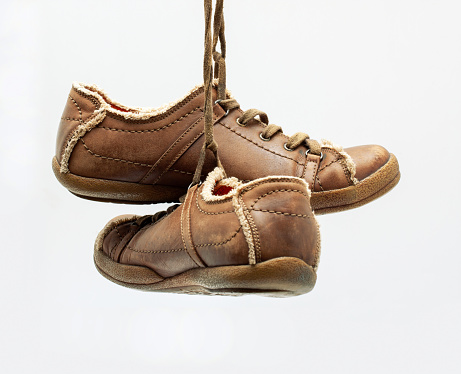 A pair of premium calfskin boots on a red background. Horizontal shot. Men's shoe ideas.