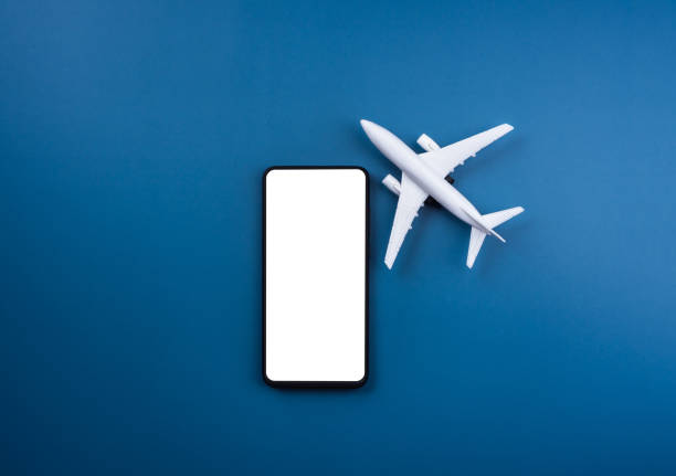 istock White blank screen mockup on smartphone with white clean airplane model toy on blue background. Air ticket booking on mobile phone app, online travel, and vacation insurance concepts. 1364905324