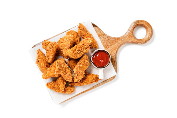 crispy fried breaded chicken breast strips Delicious crispy fried breaded chicken breast strips with ketchup. Isolated on white background. top view chicken finger stock pictures, royalty-free photos & images