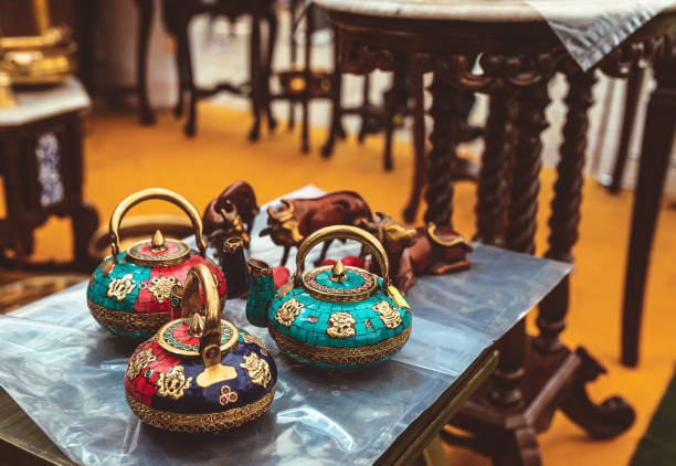 traditional indian colourful tea pots on display at a store. Beautiful hand crafted designer tea pots on display at home decor shop. Traditional Indian handmade kettles with colourful stones and intricate patterns at a festival fair. singh stock pictures, royalty-free photos & images
