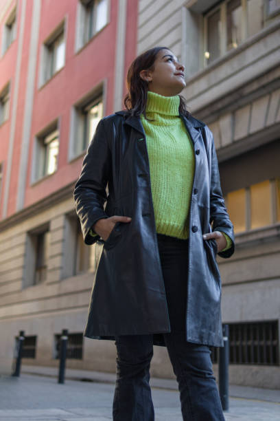 istock Latin young lady standing on a street looking up 1364906554