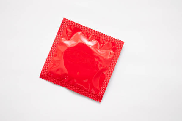 Pack of red condom on white background Pack of red condom on white background. condom photos stock pictures, royalty-free photos & images