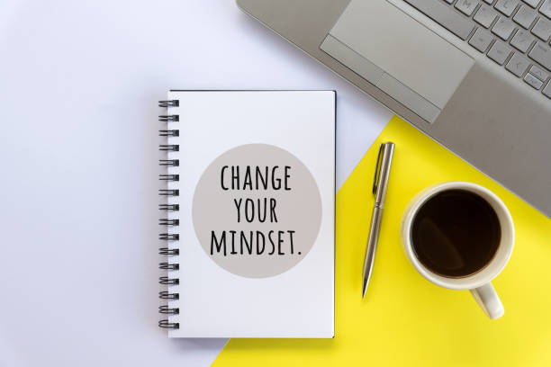istock Change your mindset. A positive text sign on a notebook with pen, coffee drink and the keyboard on the table. 1364908057