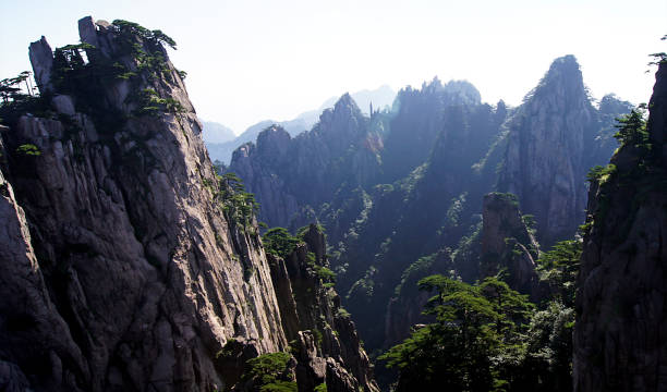 Huangshan, Yellow Mountain, Anhui, China Huangshan (Yellow Mountain) is a rugged mountain range with more than 70 sharp peaks in the eastern Chinese province of Anhui. The region has low clouds, distinctively shaped granite rocks, and crooked pines that have been the subject of many classic poems and paintings. huangshan mountains stock pictures, royalty-free photos & images