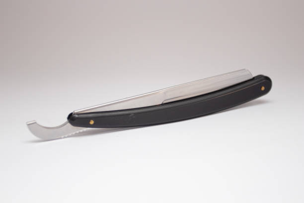 istock Black straight dangerous razor on a white. 1364910505