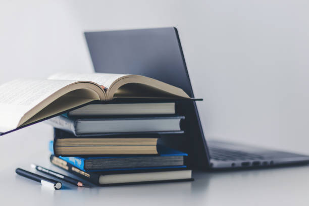 istock Computer laptop with book. Business success idea and studying concept 1364911297