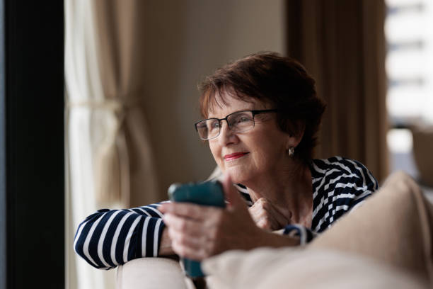 istock Smiling woman holding her phone 1364912414