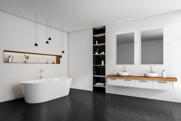 istock White bathroom interior with bathtub, sinks and mirrors, shelf with accessories 1364912620