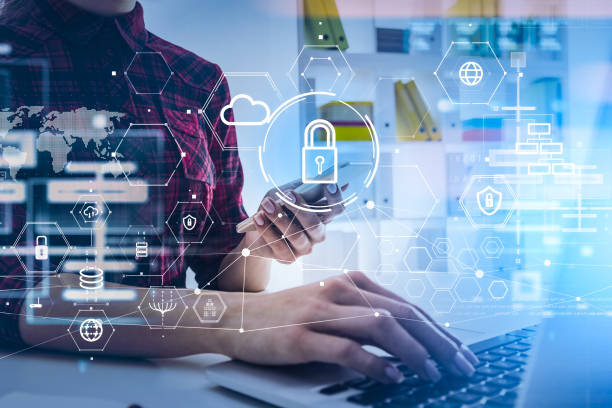 istock Businesswoman working with laptop and using smartphone by browsing the Internet, blue glowing information protection icons. Padlock, cloud and digital interface. Concept of cyber security. 1364913456