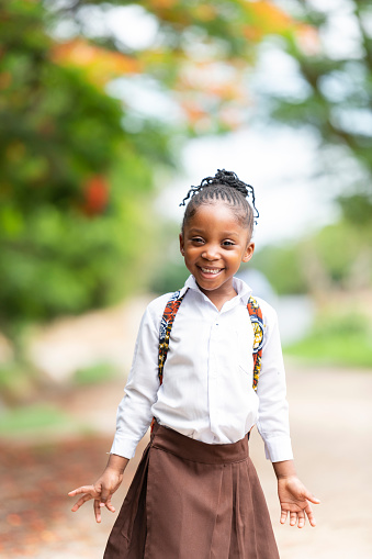 Portrait of excited young African girl ready for school