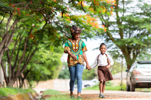 Mother walks daughter to school in rural neighbourhood
