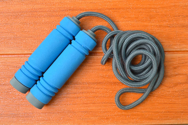 istock Jump rope isolated on a wooden background 1364913942