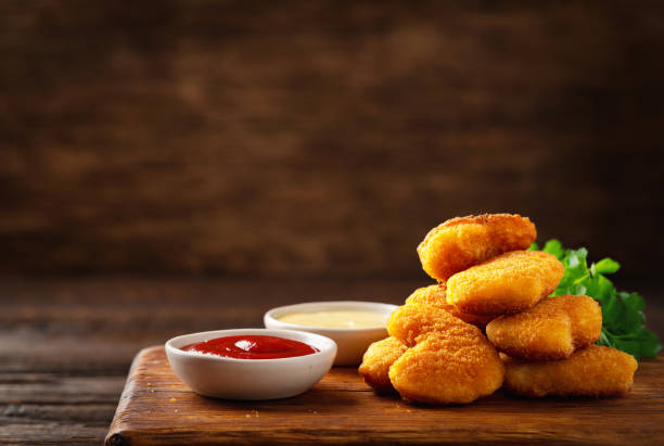 Homemade chicken nuggets and sauces with copy space Homemade chicken nuggets and sauces with copy space nugget photos stock pictures, royalty-free photos & images