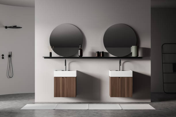 istock Light bathroom interior with sinks and mirrors, shower and towel rail ladder 1364914087