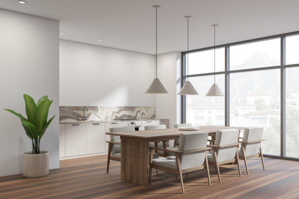 istock White kitchen interior with table and seats, wooden floor and window 1364914740