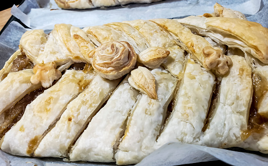 Homemade apple strudel fresh from the baking oven. Dessert that is popular all over Europe, or in other countries that once belonged to the Austro-Hungarian Empire (1867