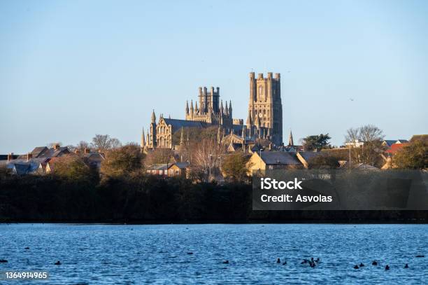 Cathedral Of Ely With A Lake Infront During Sunrise Stock Photo - Download Image Now