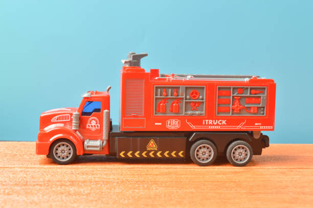 istock Plastic toy red truck on wooden table 1364915132