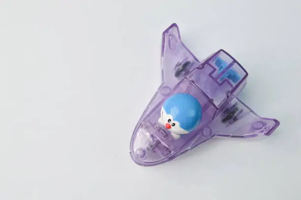Doraemon toy with plane isolated on a white background