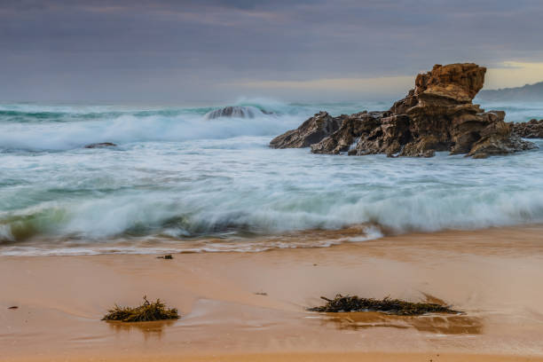 istock Rocks and waves - sunrise seascape at Bermagui 1364915416