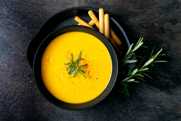 istock Pumpkin soup with linen napkin on dark background. 1364915605