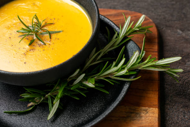 istock Pumpkin soup with linen napkin on dark background. 1364916212